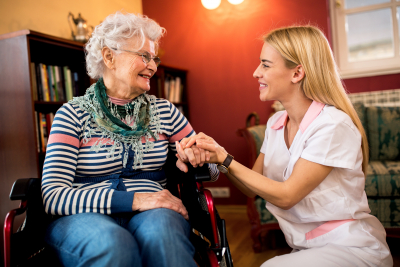 caregiver taking care of elderly woman